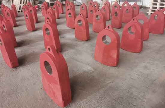 Titanium alloy bars with high manganese steel insert and hardfacing hammers